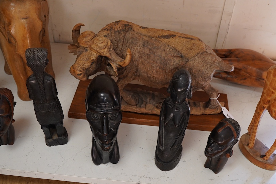 A collection of mostly Eastern and African carved wood figures to include three giraffes, a buffalo and African busts